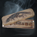 T-Rex fossil dice case holding a polyhedral set